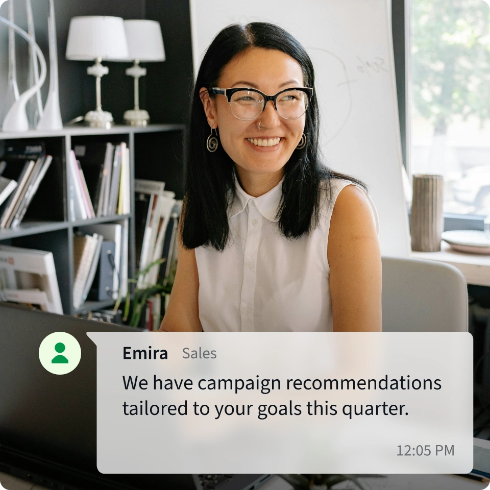 A sales professional seated in a personal office setting is ready to share information with a partner. 
