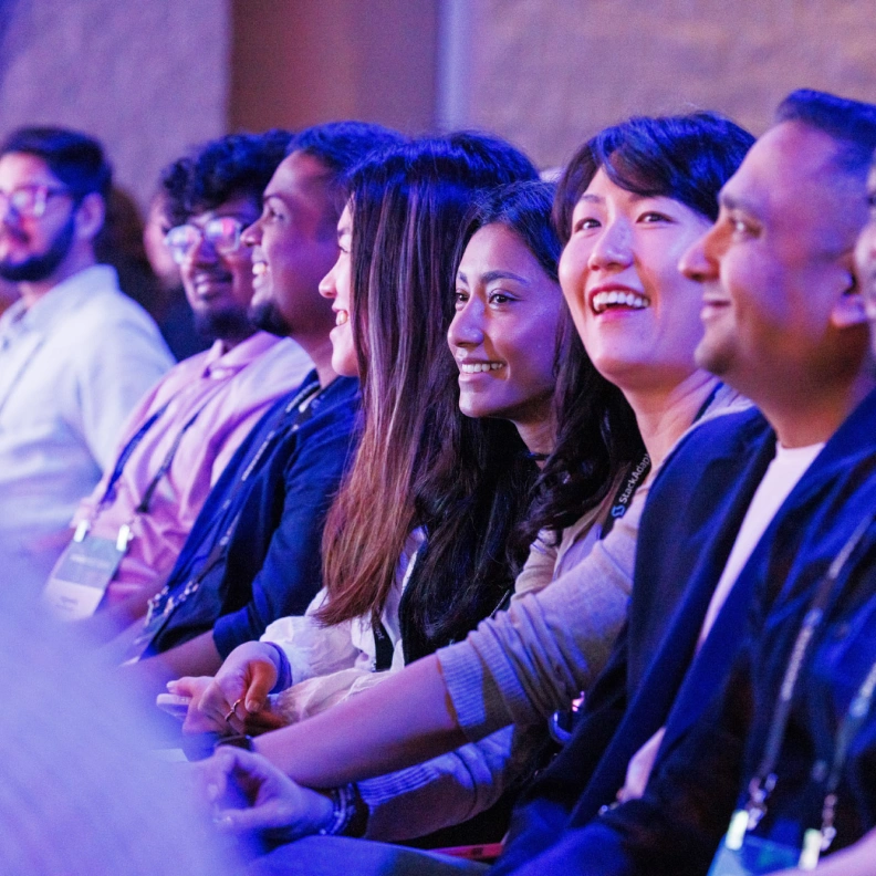 A group of individuals in an audience seated during an event.