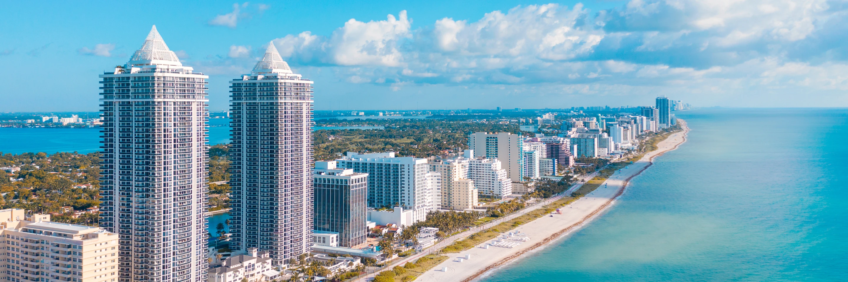 Aerial view of Miami Beach coastline and high-rise buildings.