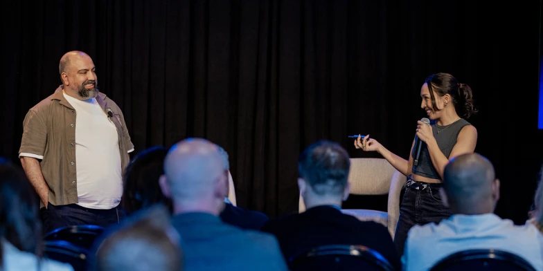 Simone Hummel, Creative Strategy Lead at StackAdapt, and Farzin Ghayour, Senior Manager of Creative Studio at StackAdapt, presenting on stage during a featured session at Conversion 2026.