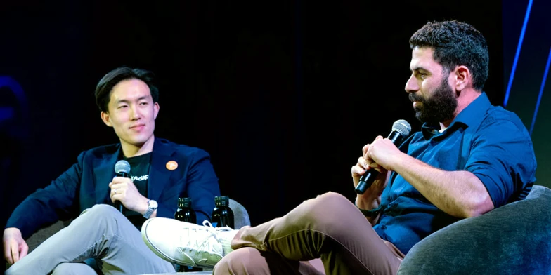 Michael Zhong, Verticals & Performance Senior Lead at StackAdapt, and Adam Telian, Head of Media at GYK, speaking on stage during a panel discussion at Conversion 2026.