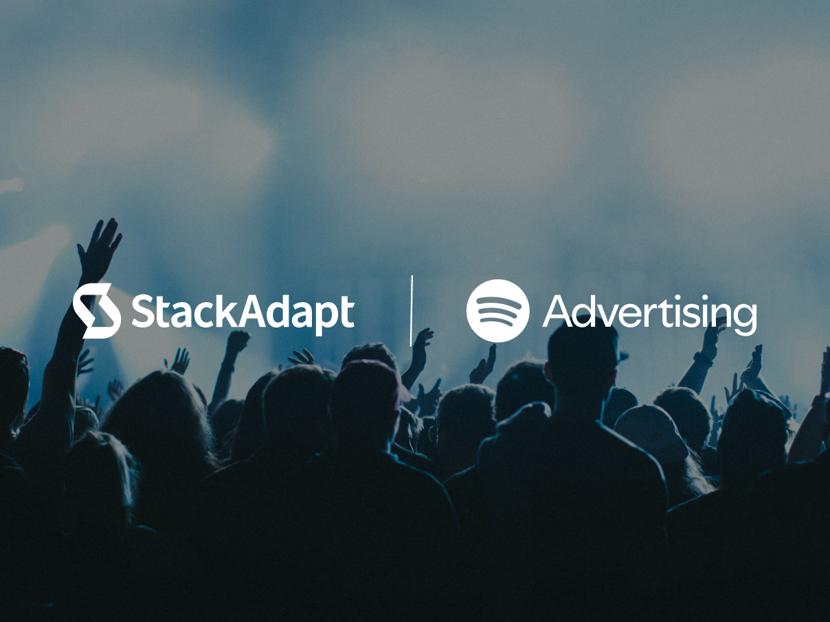 StackAdapt and Spotify logos on a background of shadows of people in a crowd