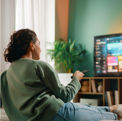 Person sitting on couch watching TV